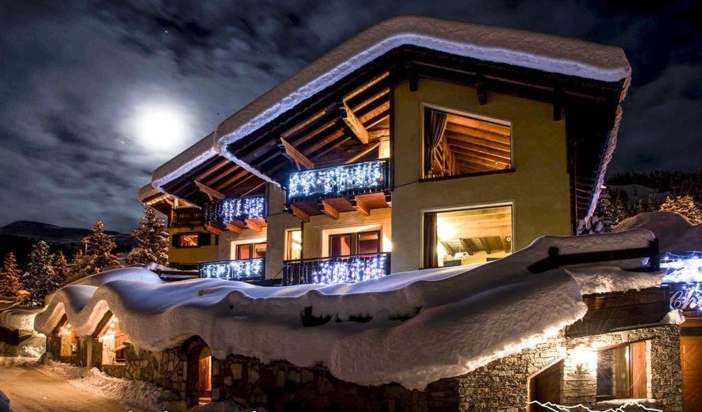 a house covered in snow at night at Chalet Garden in Livigno