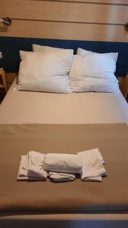 łóżko z 2 poduszkami i 2 ręcznikami w obiekcie Le Ried Camping To hapi w mieście Boofzheim