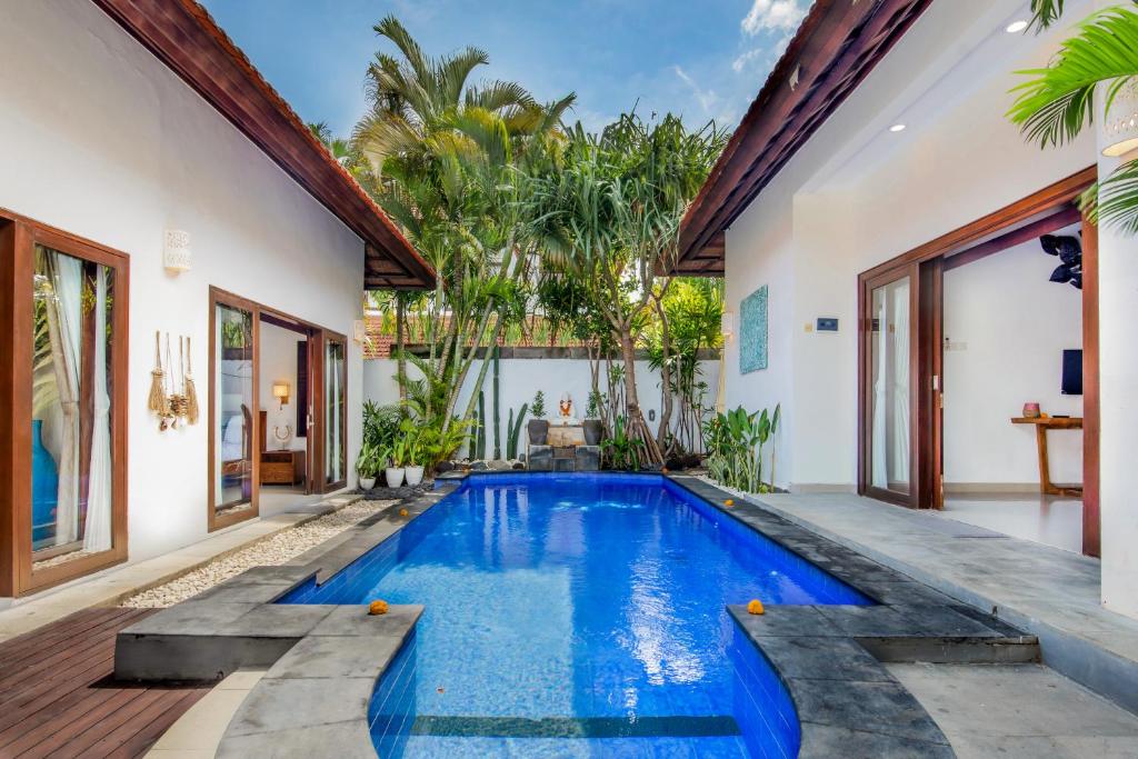 a swimming pool in the backyard of a house at Villa Joyosa in Seminyak