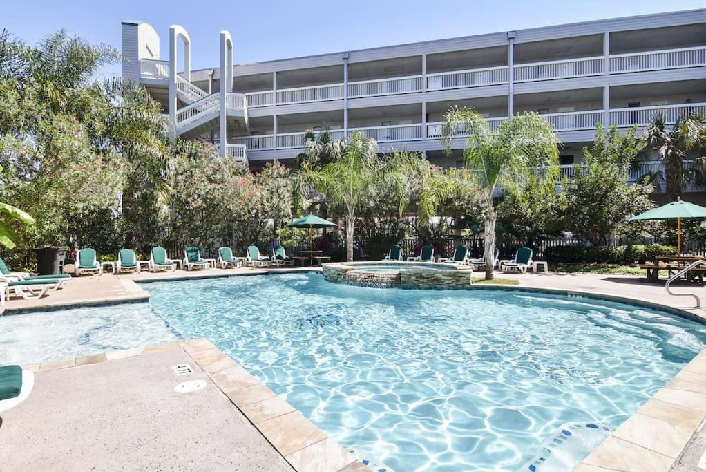 a large swimming pool with chairs and a building at Sea Chase with an ocean view at Casa Del Mar in Galveston