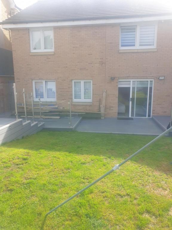 a yard with a hose in front of a building at Yementry court in Cambuslang