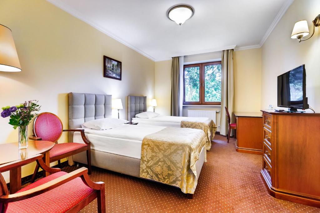 Posteľ alebo postele v izbe v ubytovaní Hotel Pan Tadeusz