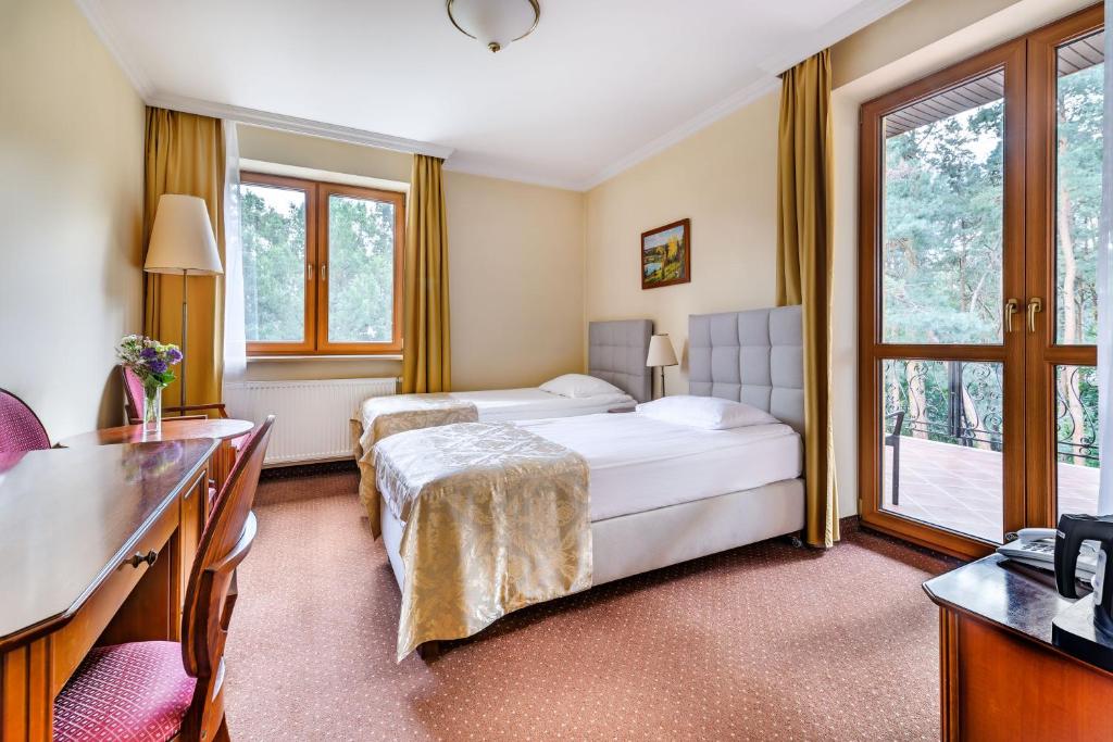 Posteľ alebo postele v izbe v ubytovaní Hotel Pan Tadeusz