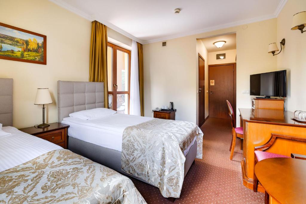 Posteľ alebo postele v izbe v ubytovaní Hotel Pan Tadeusz