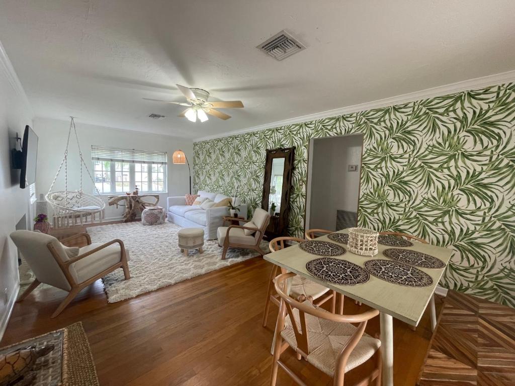 a living room with a couch and a table at Hot tub, tiki bar, outdoor shower, near Intercoastal Waterway! in West Palm Beach
