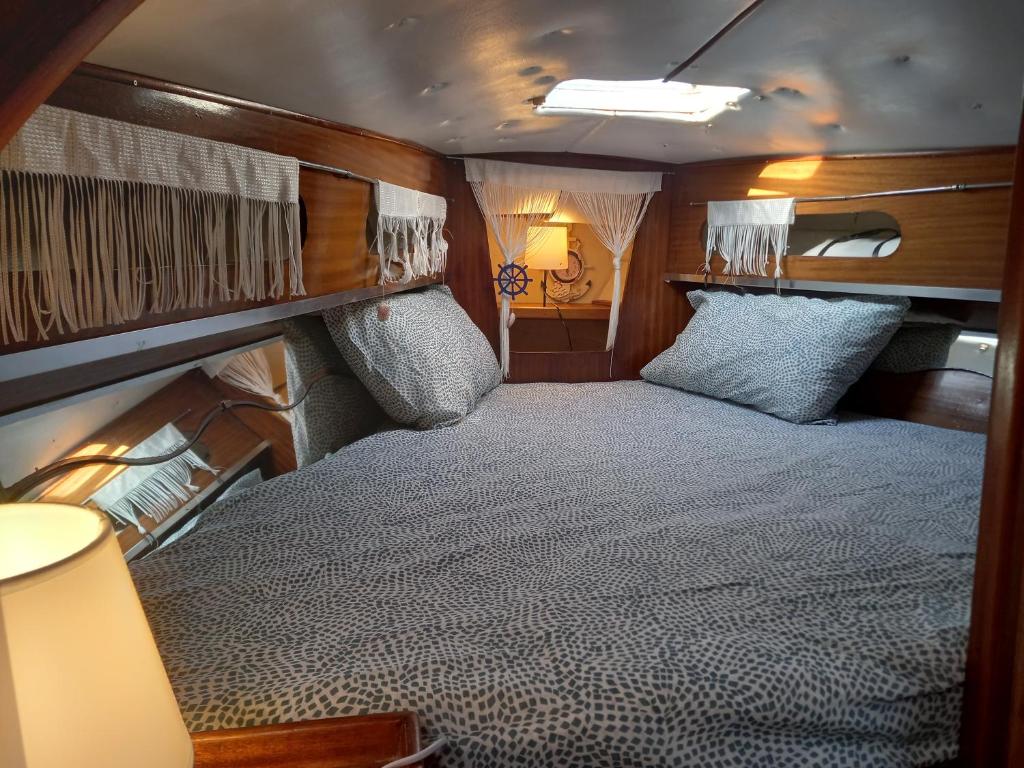 a bedroom with a bed in the back of a boat at La tua stanza a vela sul mare in Bari