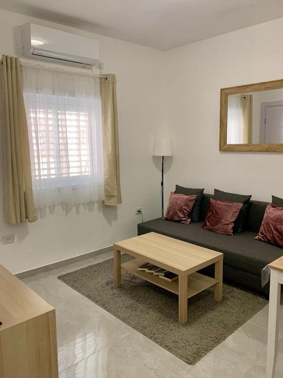 a living room with a couch and a coffee table at New 2 rooms flat fully equipped 5 min to Bat Yam beach near Tel Aviv in Bat Yam