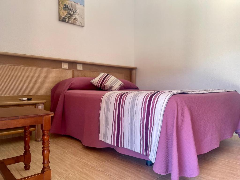 Łóżko lub łóżka w pokoju w obiekcie Hostal Noli