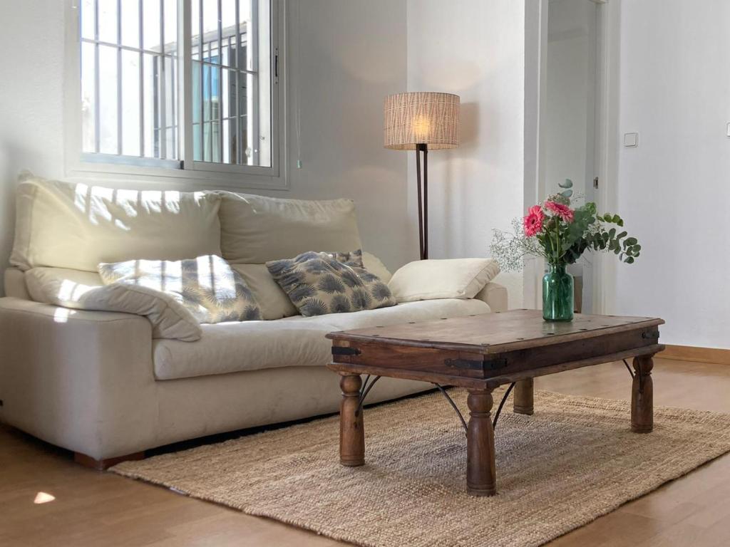 a living room with a couch and a coffee table at ATICO ALFAQUEQUE in Seville