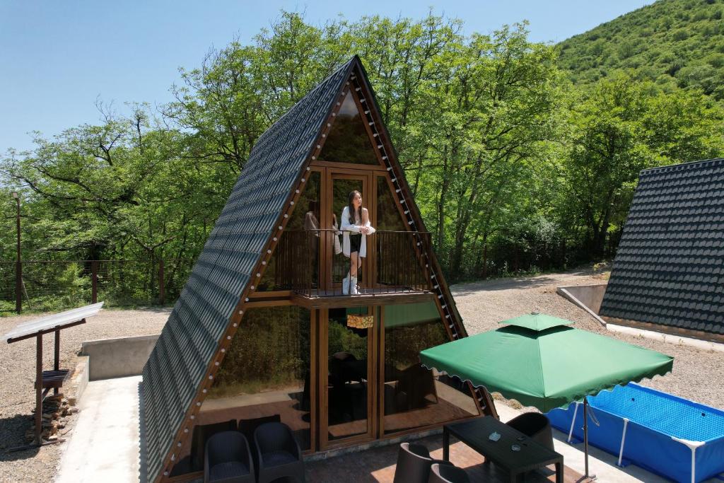a woman is standing in a triangular play house at Navasard Resort in Kapan