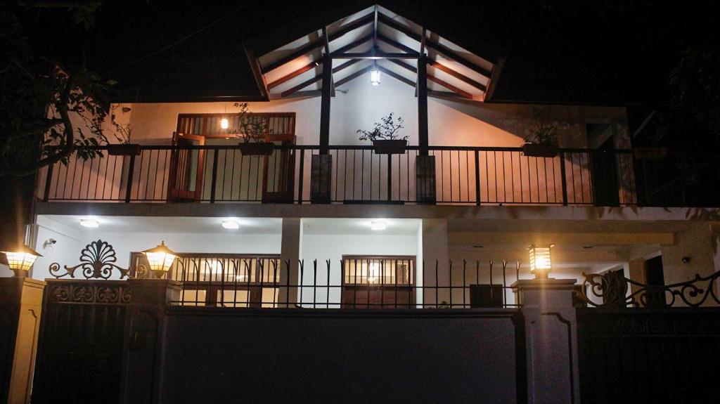 a building with a balcony at night at Arazia in Panadura