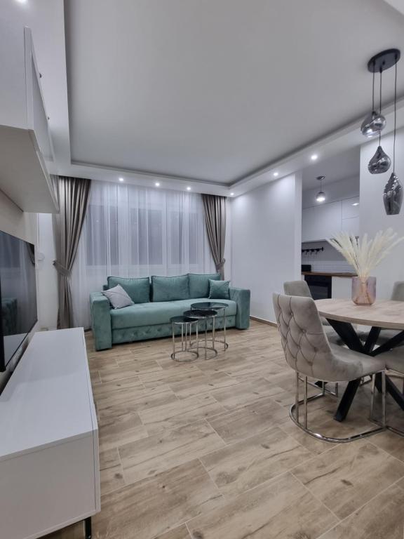 a living room with a couch and a table at Apartman Ivkovic in Sremska Mitrovica