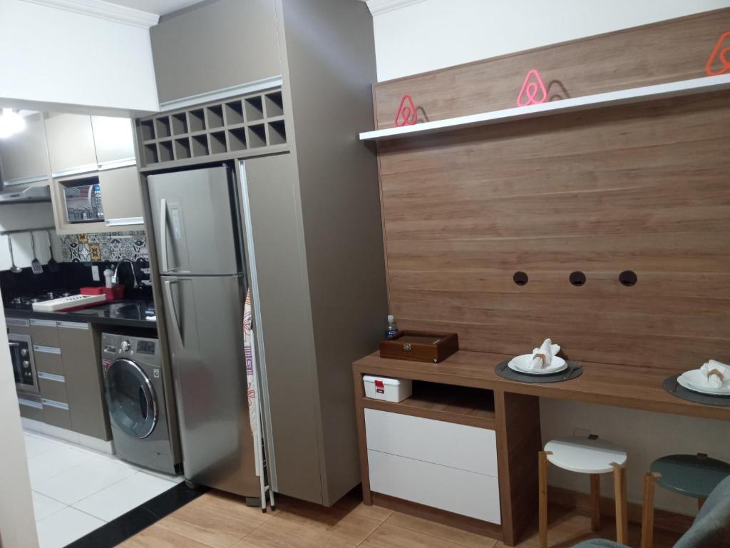 a small kitchen with a refrigerator and a counter at The Flat 15 in Campinas