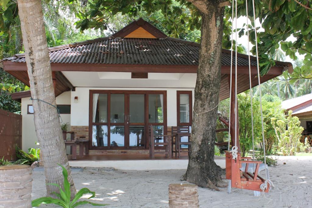a small house with a large glass door at Sea Scene Resort in Wok Tum