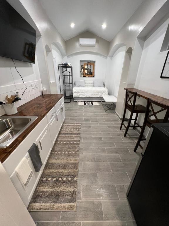 a kitchen with a sink and a couch in a room at Tiny Home in El Paso