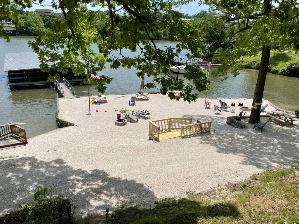 a group of people on a beach near the water at Lakeshore Fishing Cabin #2 in Lake Ozark