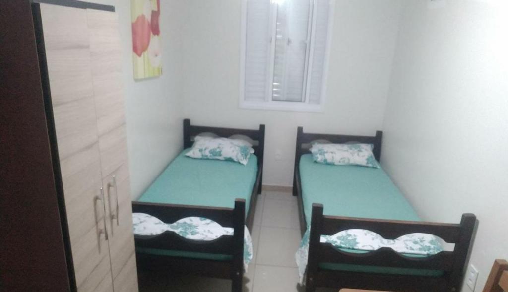 En eller flere senge i et værelse på Casa Temporada - 2 Quartos