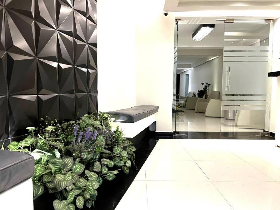 a lobby with a large potted plant on the floor at Apartment in the touristic heart of Mexico City in Mexico City