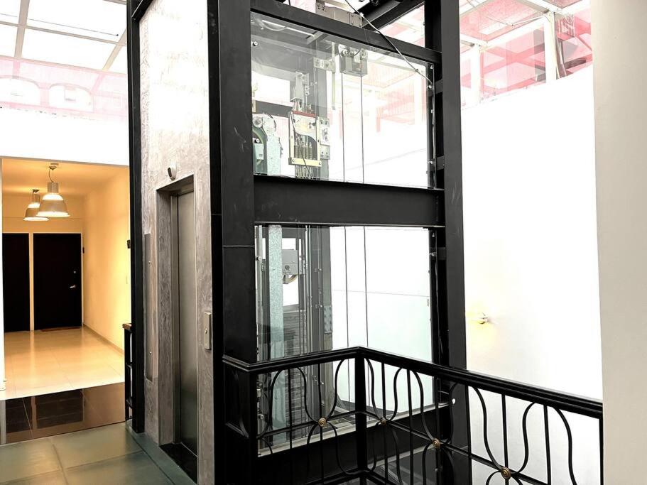 a black staircase in a building with a window at Apartment in the touristic heart of Mexico City in Mexico City