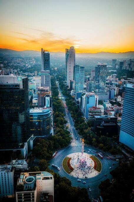 an aerial view of a city with a large building at Apartment in the touristic heart of Mexico City in Mexico City