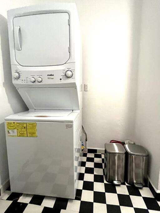a small kitchen with a stove and a checkered floor at Apartment in the touristic heart of Mexico City in Mexico City