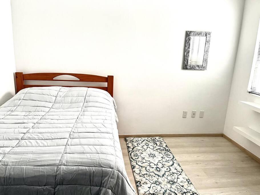 a bedroom with a bed and a rug on the floor at Apartment in the touristic heart of Mexico City in Mexico City