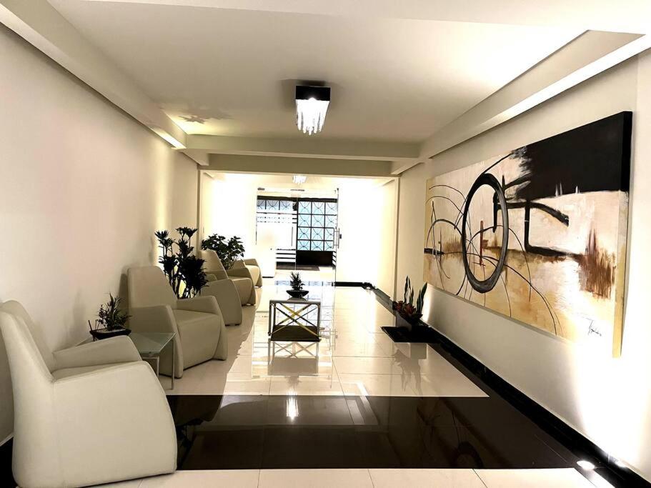 a living room with couches and a painting on the wall at Apartment in the touristic heart of Mexico City in Mexico City