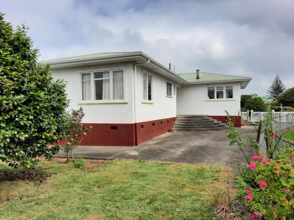 a white house with a driveway at Mary's Place in Opotiki