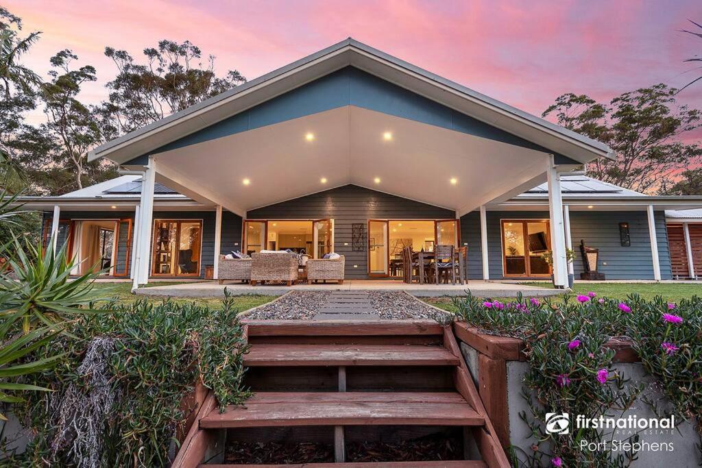 a home with a pathway leading to a house at Deja Blue in Anna Bay