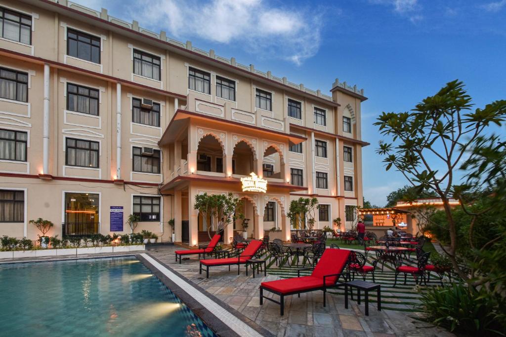 a hotel with a pool in front of a building at Ranbanka Heritage Resort in Bhilwara