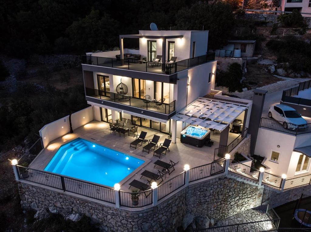 an aerial view of a house with a swimming pool at Villa Neda Heated Pool, Hot-tub, Sauna, 3 bedrooms in Blato na Cetini