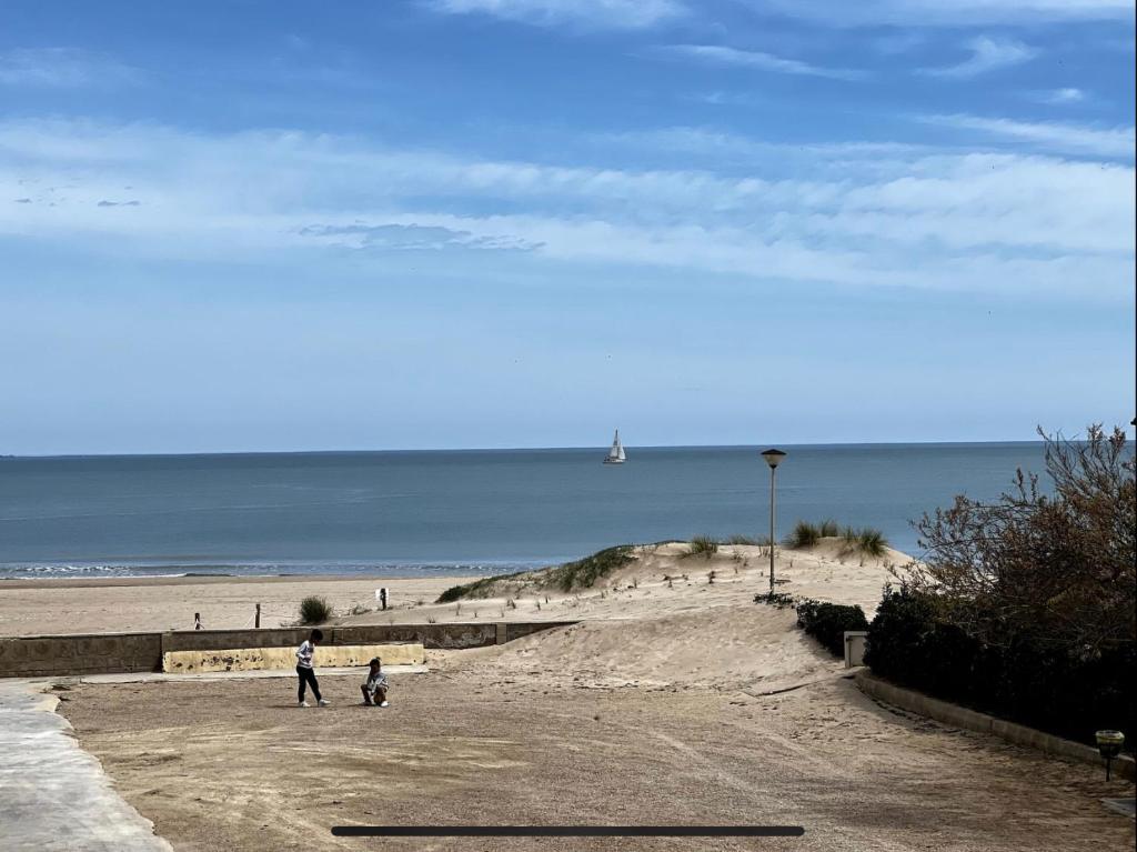 a man and a child walking on a beach at Beach Retreat in Valencia