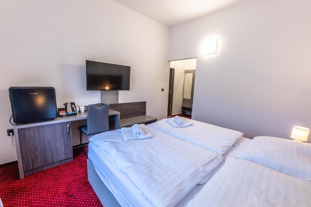 Postel nebo postele na pokoji v ubytování Hotel Orka