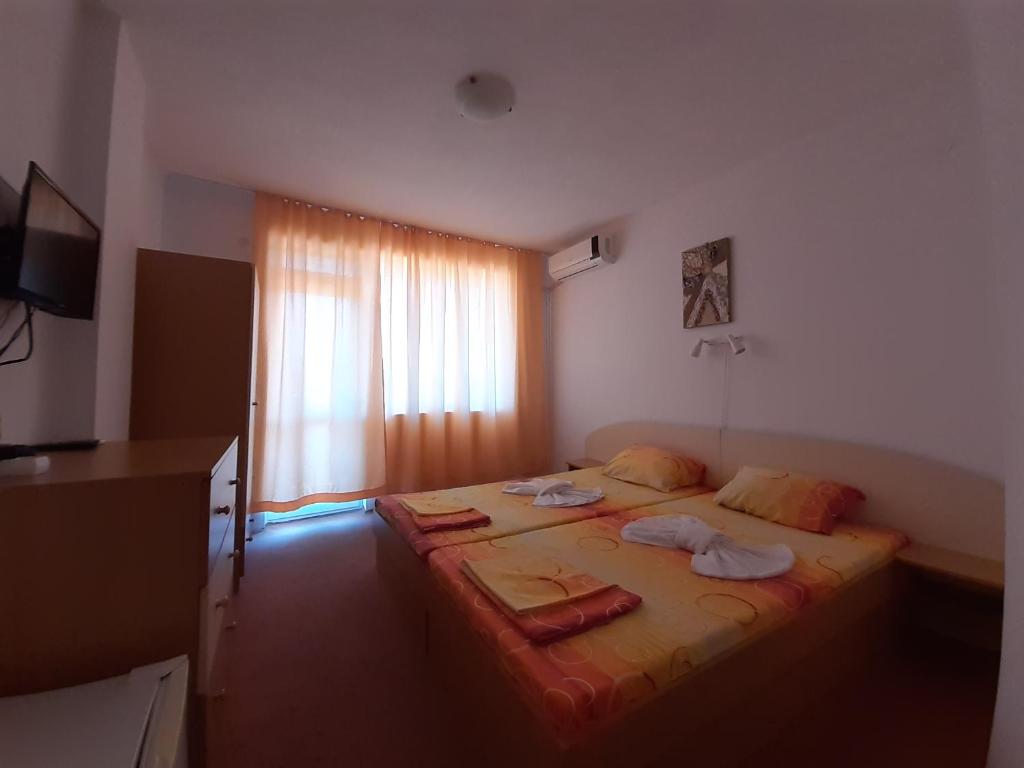 Postel nebo postele na pokoji v ubytování Guest House Malkata Stopanka