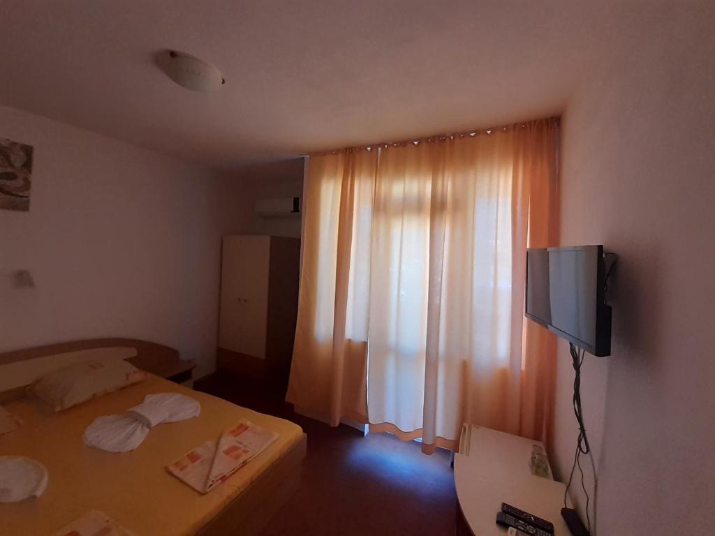 Postel nebo postele na pokoji v ubytování Guest House Malkata Stopanka