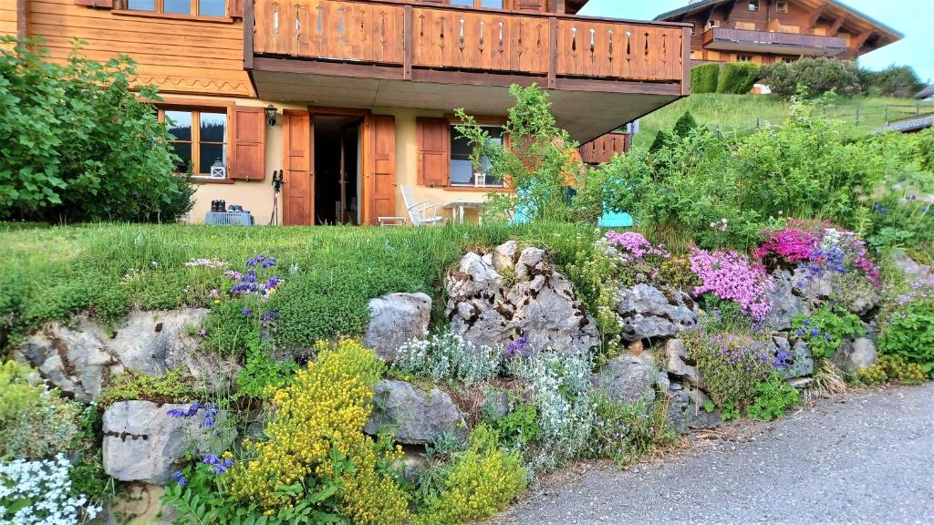 a garden of flowers in front of a house at Le Sapin in Les Diablerets