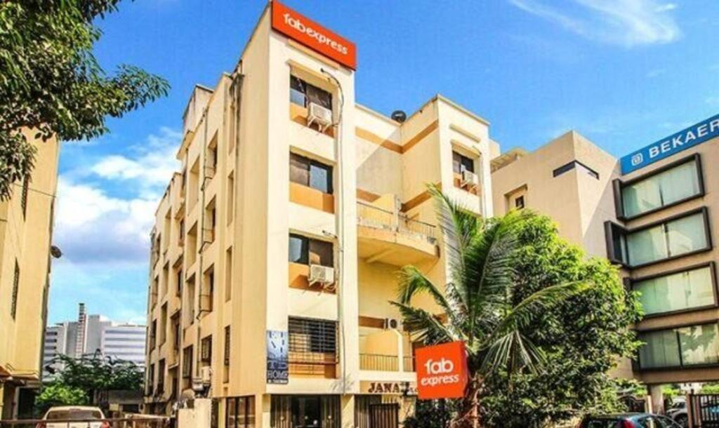 a building with a sign on the side of it at FabHotel East Field Homes in Pune