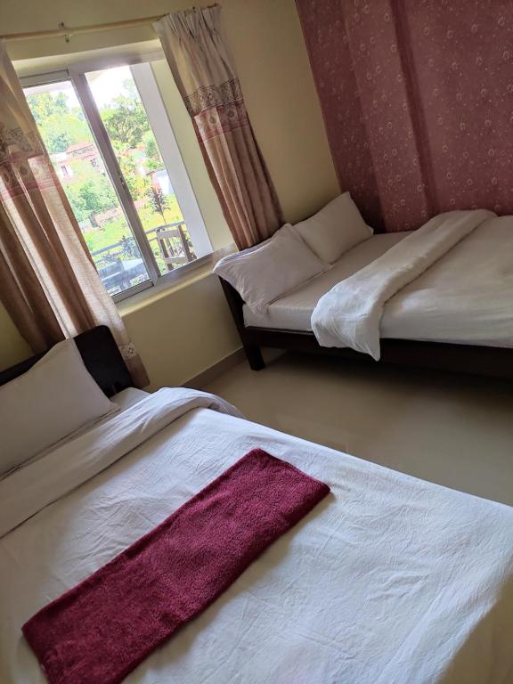 Ein Bett oder Betten in einem Zimmer der Unterkunft Hotel Green Hill View