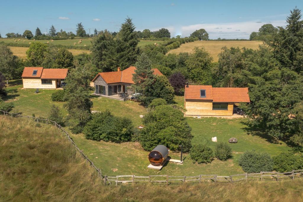 an aerial view of a house on a hill at Les Lodges du Morvan in Brazey-en-Morvan