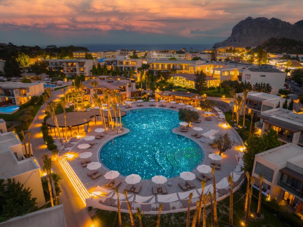 an overhead view of a pool in a city at night at Port Royal Villas and Spa - Adults Only in Kolymbia