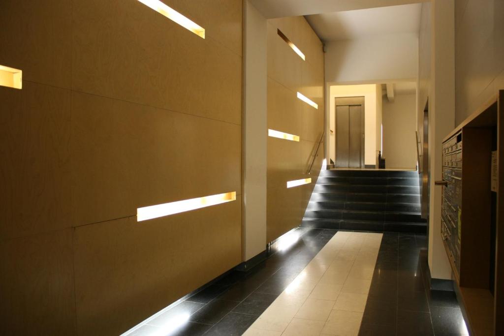 a hallway with stairs and lights in a building at GoVienna Luxury Oldtown Apartment in Vienna