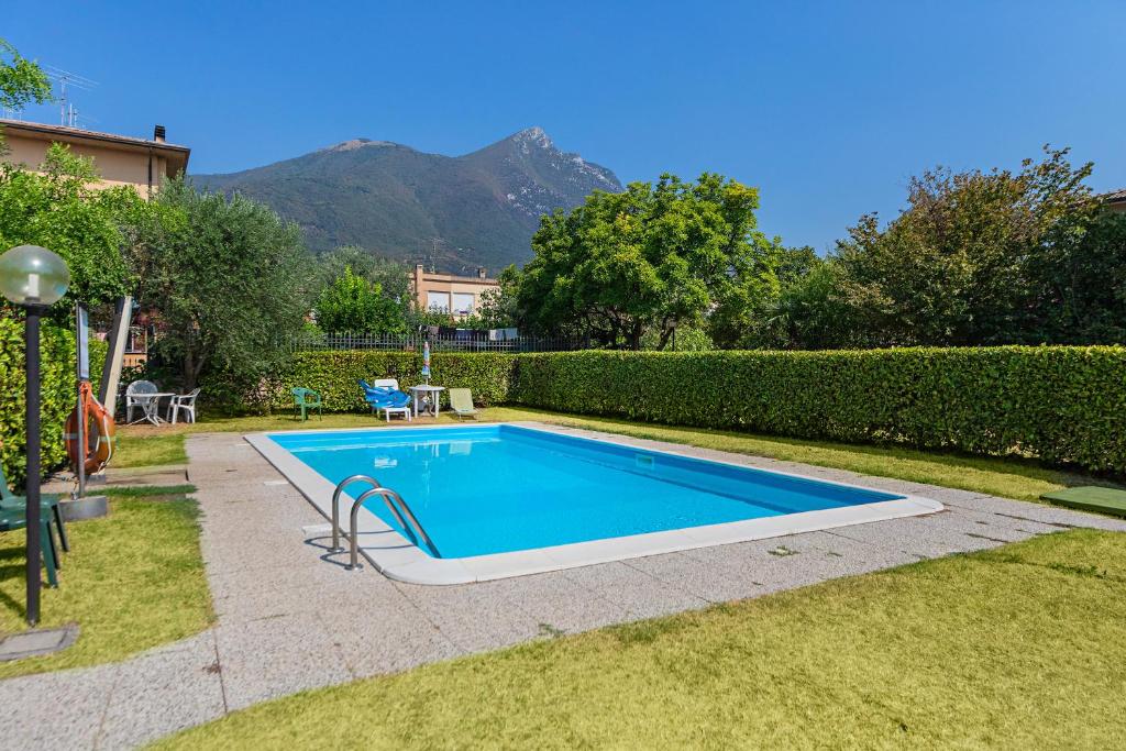 a swimming pool in the yard of a house at Residence Mimosa PT2 by Wonderful Italy in Toscolano Maderno