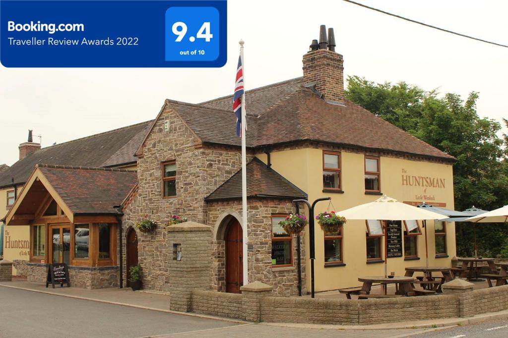 a building with an american flag in front of it at The Huntsman of Little Wenlock in Telford