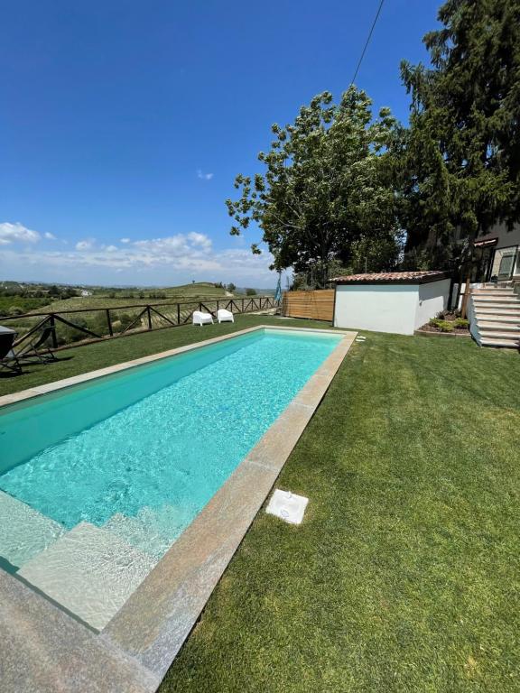 a swimming pool in the yard of a house at La Casa del Tiglio in Mombaruzzo