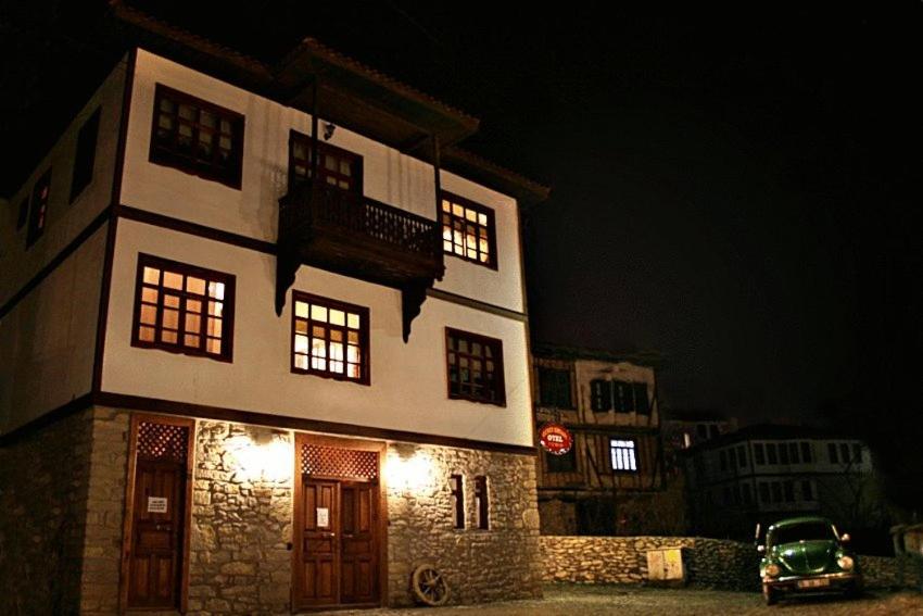 a building with a car parked in front of it at night at Guney Konak in Safranbolu