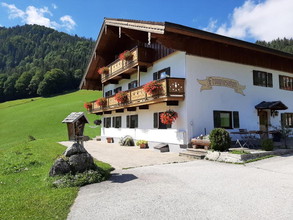 a large white building with a balcony on the side at Fronwieshof in Ramsau