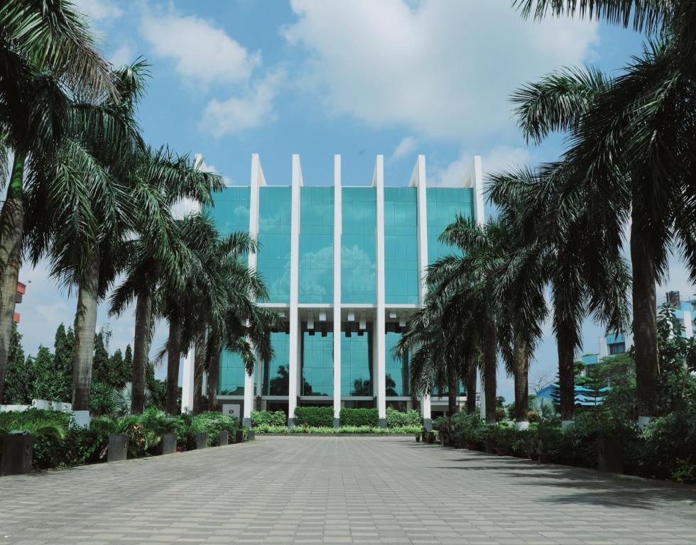 a view of a building with palm trees at Hotel Sandy's Tower in Bhubaneshwar