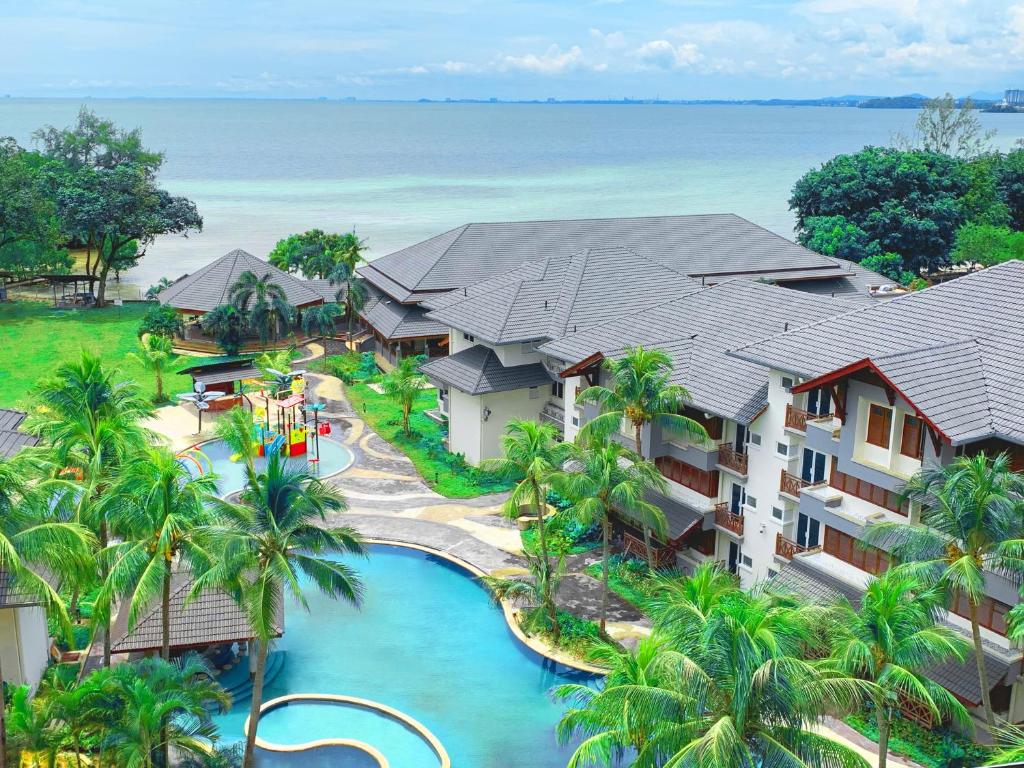 an aerial view of a resort with a pool and the ocean at Villea Port Dickson in Port Dickson