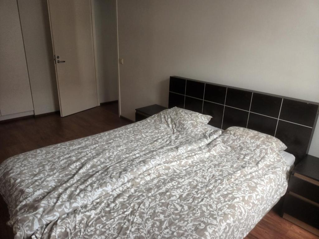 a bedroom with a bed with a white comforter at FREE Sauna and Laundry, 5min to Metro, 15min to Center in Espoo