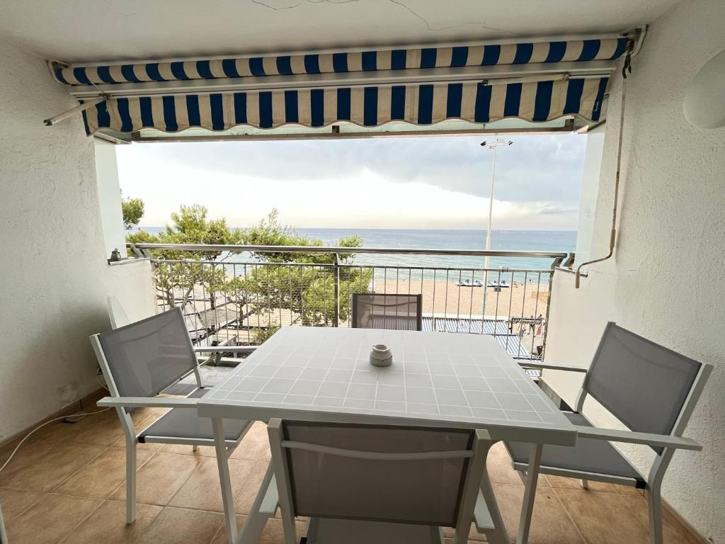 een tafel en stoelen met uitzicht op de oceaan bij Elypalace 1-9 in Platja  d'Aro